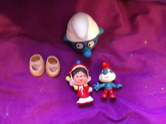 There are some toys on a pink cloth.