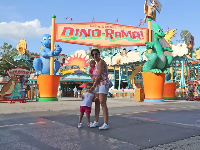 In this picture there is a woman standing and smiling and she is holding the baby and there is a...