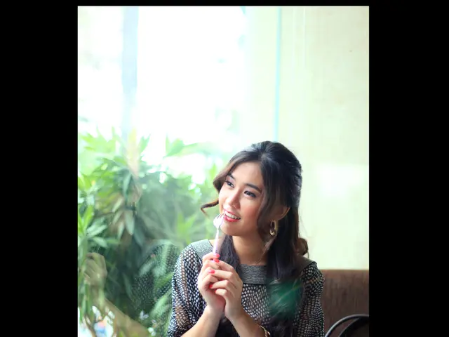 In the image there is a woman,she is holding a fork and there is a bag beside the woman. In front...