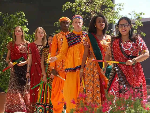 In this image we can see some group of lady persons wearing traditional attire also holding dandiya...