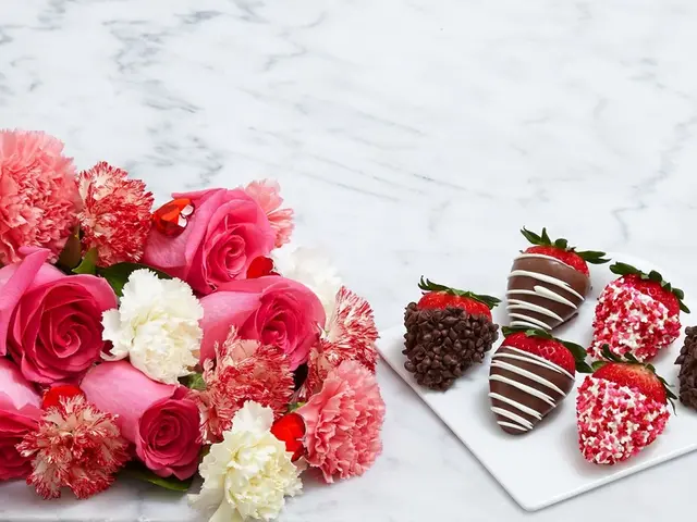 There are few roses in the left corner and there are few strawberries which has something placed on...