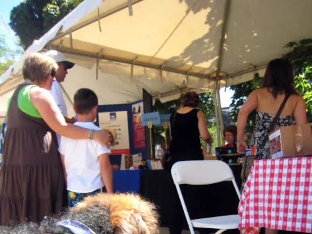 As we can see in the image there is a cream color cloth, few people here and there, a tree, poster,...