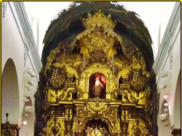 In the picture I can see sculptures, candles, wall, pillars, white color cloth and some other...
